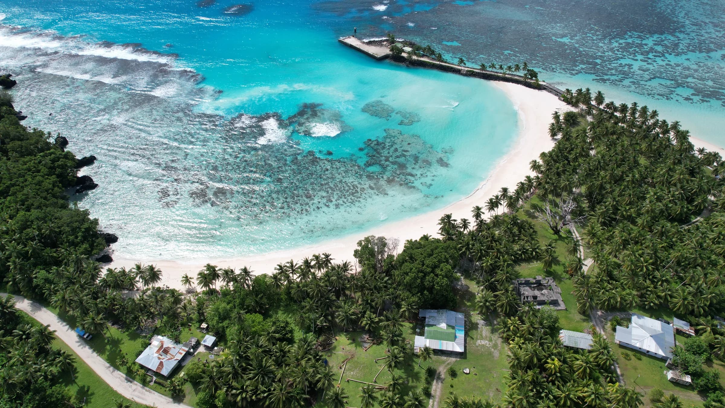 Aerial view of Rotuma's turquoise lagoon, reef, palms, and beach